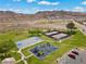 Neighborhood park with playground, basketball court, and tennis courts with desert mountains behind at 262 Big Horn Dr, Boulder City, NV 89005