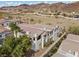Aerial view of multi-Gathering stucco townhomes with balconies, red roofs, and mountain views at 262 Big Horn Dr, Boulder City, NV 89005