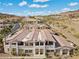 Image of stucco townhomes with red roofs, mountain views and landscaping near a street at 262 Big Horn Dr, Boulder City, NV 89005