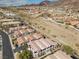 Aerial view of multi-Gathering townhomes with red roofs on a sunny day with desert hills behind at 262 Big Horn Dr, Boulder City, NV 89005