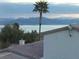 A stunning view with a palm tree in front of a lake and mountains at 262 Big Horn Dr, Boulder City, NV 89005