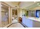 This primary bath boasts a vanity with double sinks and a glass shower at 2747 Paradise Rd # 801, Las Vegas, NV 89109