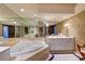 The bathroom features a large soaking tub, a vanity with double sinks and a mirror that spans the wall at 2747 Paradise Rd # 801, Las Vegas, NV 89109