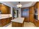 Kitchen features wood cabinets, stone floors, and a marble-topped island with a wine fridge at 2747 Paradise Rd # 801, Las Vegas, NV 89109