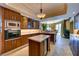 Well-lit kitchen features wood cabinetry, a stone tile floor, and a marble-topped island at 2747 Paradise Rd # 801, Las Vegas, NV 89109