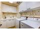 This laundry room features front load washer and dryer with built-in cabinets at 2747 Paradise Rd # 801, Las Vegas, NV 89109