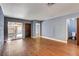 Bright living room with blue accent wall, wood flooring, and a sliding door to outdoor space at 3024 Saint George St # G, North Las Vegas, NV 89030