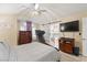 Bedroom with a vaulted ceiling, barn door entry to the bathroom, and light-colored laminate floors at 3427 Meridale Dr, Las Vegas, NV 89117