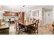 Open dining room next to a kitchen area with dark wood cabinets at 3427 Meridale Dr, Las Vegas, NV 89117