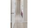 Hallway view of bright bathroom with tiled floor and wooden cabinets at 3550 Bay Sands Dr # 2087, Laughlin, NV 89029