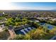 A vibrant community aerial view showcasing the tennis courts and the scenic mountain backdrop at 431 Tranquil Peak Ct, Henderson, NV 89012