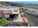 Overhead shot of the back patio showcasing the outdoor seating area, modern fire pit, and the surrounding landscape at 431 Tranquil Peak Ct, Henderson, NV 89012