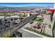 Elevated perspective of the back patio, displaying elegant furnishings, a cozy fire pit, and scenic neighborhood views at 431 Tranquil Peak Ct, Henderson, NV 89012