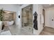 Luxurious bathroom featuring a glass-enclosed shower, freestanding tub, and elegant tile work at 431 Tranquil Peak Ct, Henderson, NV 89012