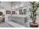 Elegant bathroom features double vanity, herringbone tile accent wall, pendant lighting, and a decorative plant at 431 Tranquil Peak Ct, Henderson, NV 89012