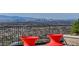 Expansive city views from this upper level patio with comfortable lounge furniture at 431 Tranquil Peak Ct, Henderson, NV 89012