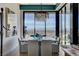 Elegant dining room with a modern chandelier, spacious table, and stunning city views at 431 Tranquil Peak Ct, Henderson, NV 89012