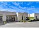 Modern home featuring a glass garage door, desert landscaping, and contemporary design elements at 431 Tranquil Peak Ct, Henderson, NV 89012
