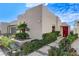 Modern home with desert landscaping, featuring a red door and decorative cacti at 431 Tranquil Peak Ct, Henderson, NV 89012