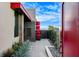 Modern home with a red accent roof and a black gate, showcasing contemporary architectural design at 431 Tranquil Peak Ct, Henderson, NV 89012