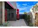 Contemporary home entrance featuring a red door, modern landscaping, and artistic design elements at 431 Tranquil Peak Ct, Henderson, NV 89012