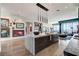 Open concept kitchen with waterfall island, modern lighting, and city views at 431 Tranquil Peak Ct, Henderson, NV 89012
