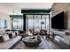 Modern living room featuring floor-to-ceiling windows and a sleek fireplace at 431 Tranquil Peak Ct, Henderson, NV 89012