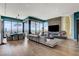 Modern living room with floor-to-ceiling windows and a sleek fireplace at 431 Tranquil Peak Ct, Henderson, NV 89012