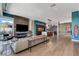 Spacious open concept living room with modern fireplace, surfboard decoration, and stylish decor at 431 Tranquil Peak Ct, Henderson, NV 89012