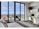 Bright main bedroom featuring floor to ceiling windows, city skyline views, and built-in shelving at 431 Tranquil Peak Ct, Henderson, NV 89012