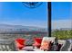Outdoor seating area with orange end tables, a canopy, and a skyline view of the city at 431 Tranquil Peak Ct, Henderson, NV 89012