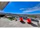 Expansive patio featuring comfortable seating, a fire pit, and stunning mountain and city views at 431 Tranquil Peak Ct, Henderson, NV 89012