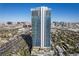 View of Palms Place high-rise tower with blue glass exterior, showcasing architecture and surrounding cityscape at 4381 W Flamingo Rd # 2712, Las Vegas, NV 89103