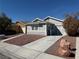 Charming single-story home with a well-maintained front yard and long driveway at 4661 Hutchinson Dr, Las Vegas, NV 89147