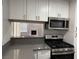 A modern kitchen with stainless steel appliances and granite countertops at 4661 Hutchinson Dr, Las Vegas, NV 89147