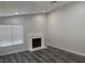 Bright living room with a fireplace, recessed lighting, and stylish laminate flooring at 4661 Hutchinson Dr, Las Vegas, NV 89147