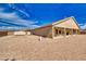 The property's backyard featuring a covered patio, outdoor furniture, and lots of stone landscaping at 5071 Andover Ct, Pahrump, NV 89061