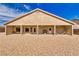 The property's backyard featuring a covered patio, outdoor furniture, and a barbecue at 5071 Andover Ct, Pahrump, NV 89061