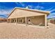 View of the house's backyard, a covered patio, and an outdoor hammock at 5071 Andover Ct, Pahrump, NV 89061
