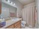 Full bathroom featuring a single sink vanity, granite countertops and shower with curtain at 5071 Andover Ct, Pahrump, NV 89061