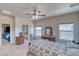 Bright bedroom with ceiling fan, carpeted floor and a view into the bathroom with a large bathtub at 5071 Andover Ct, Pahrump, NV 89061