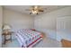 Bedroom with neutral walls, carpeted floors, and ceiling fan with simple decor and standard closet at 5071 Andover Ct, Pahrump, NV 89061