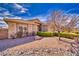 Front yard features desert landscaping, a healthy tree and well maintained bushes at 5071 Andover Ct, Pahrump, NV 89061