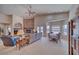 Open-concept living room with a stone fireplace, plush seating, and a dining area nearby at 5071 Andover Ct, Pahrump, NV 89061