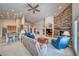 Bright, airy living room featuring a stone fireplace, dining space, and open access to the kitchen at 5071 Andover Ct, Pahrump, NV 89061