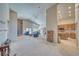 Spacious living room with a stone fireplace, vaulted ceilings, and large windows at 5071 Andover Ct, Pahrump, NV 89061