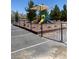 Community playground featuring play structures, a shade canopy, and secure fencing at 5071 Andover Ct, Pahrump, NV 89061