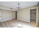 This bedroom features wood floors, a modern light fixture, and a closet at 5209 Champions Ave, Las Vegas, NV 89142