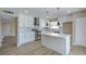 Modern kitchen with white cabinets, stainless steel appliances, island, and tiled backsplash at 5209 Champions Ave, Las Vegas, NV 89142