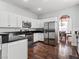 A spacious kitchen features stainless steel appliances, dark countertops, white cabinets, and wood floors at 5505 Big Sky Ln, Las Vegas, NV 89149